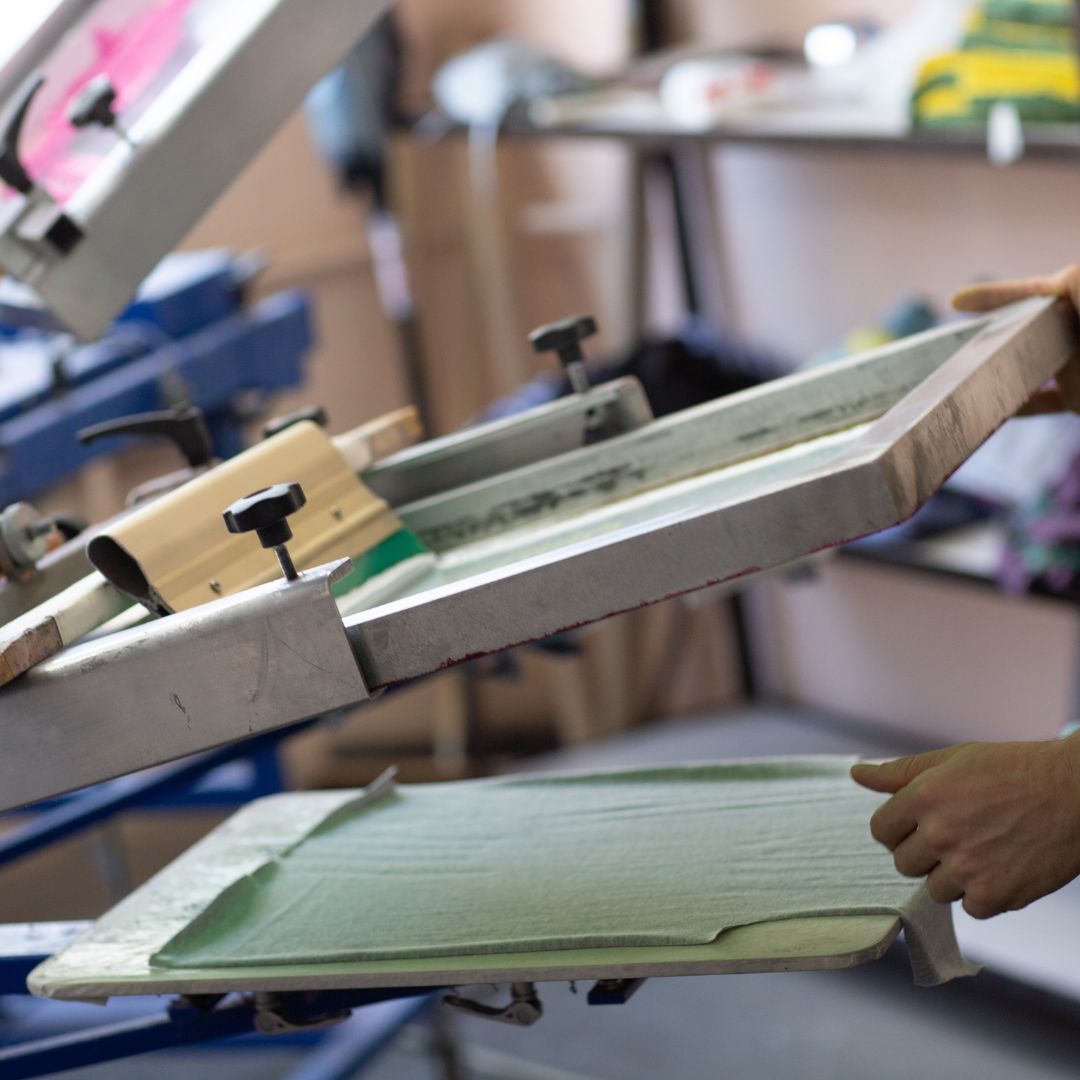 T shirt on screen printing machine getting custom print made